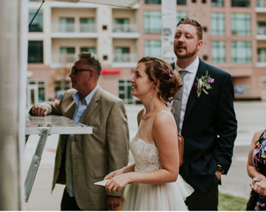 Newlyweds ordering at food truck wedding