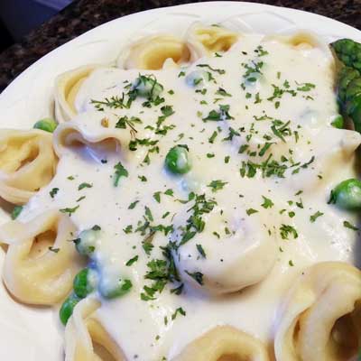 Plate of Saucy Joe's Tortellini with Romano Cream Sauce